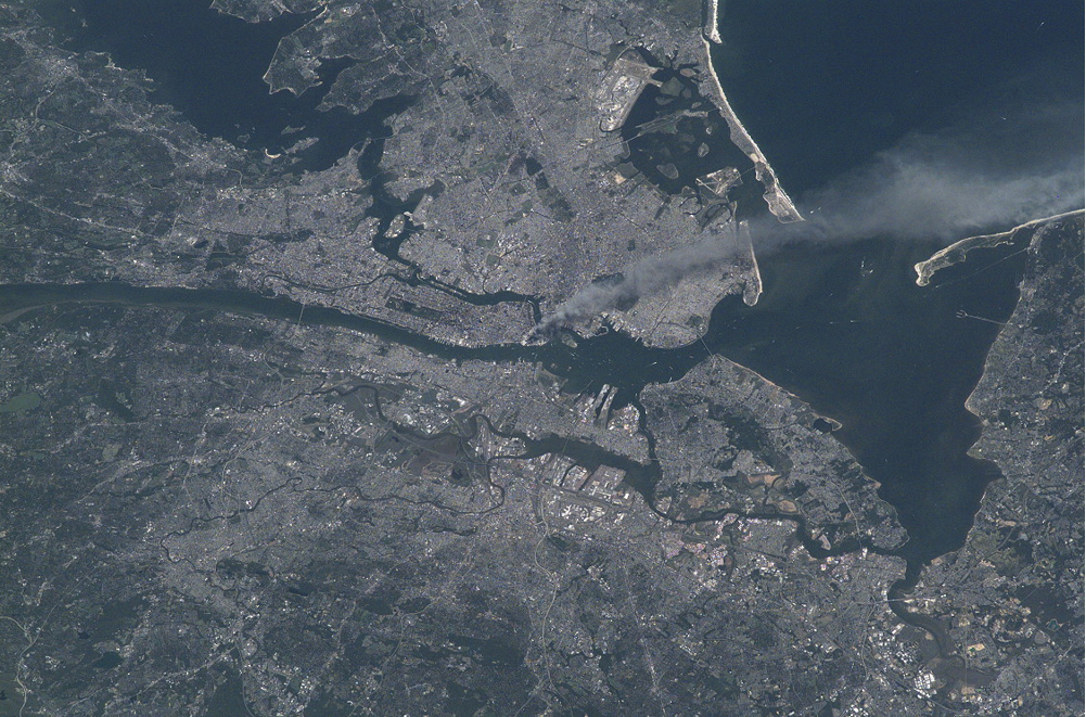 View of the greater New York City area taken by the Expedition 3 crew shows the plume of smoke from the World Trade Center site in lower Manhattan. Credits: NASA