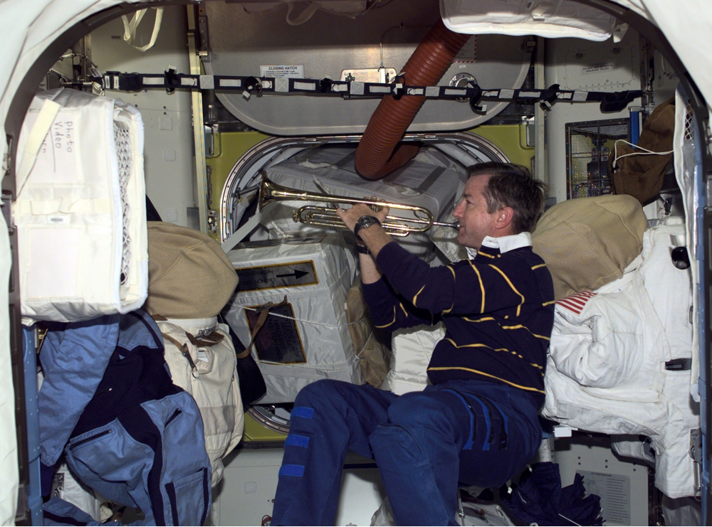 Aboard the space station, Expedition 3 Commander Frank L. Culbertson plays Taps in honor of his Naval Academy classmate Charles F. “Chic” Burlingame. Credits: NASA