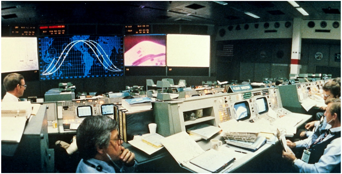 View of the Mission Control Center at NASA’s Johnson Space Center in Houston during the STS-1 mission’s first day in space as controllers assess the televised images of the missing and damaged tiles on Columbia’s OMS pods. Credits: NASA