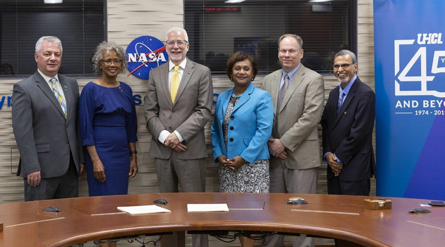Lulla, far right, represents the University Partnership and Collaboration Office at a Space Act Agreement signing ceremony in 2019. Pictured, from left, are University of Houston-Clear Lake (UHCL) President Dr. Blake, UHCL Provost Dr. Berberich, JSC Director Mark Geyer, JSC Deputy Director Vanessa Wyche, and Exploration Integration and Science Director John McCullough. Credits: NASA 