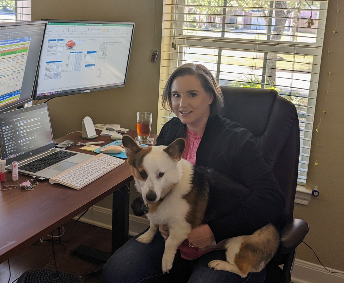 Kelly’s work-from-home setup, complete with her reluctant mascot, Hubble. Image courtesy of Kelly Hallman.