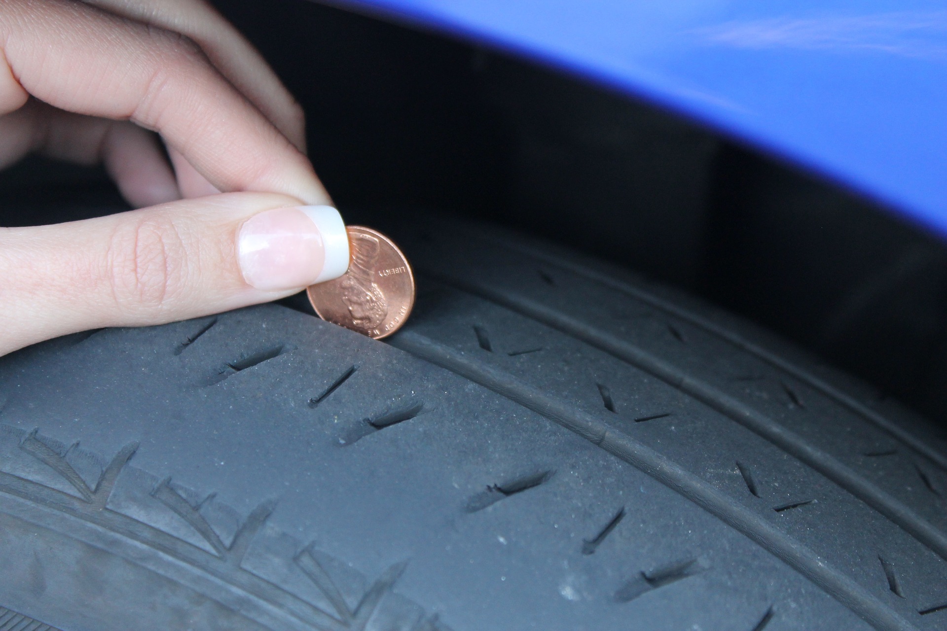 The tread on the passenger front tire is worn on the outside. What