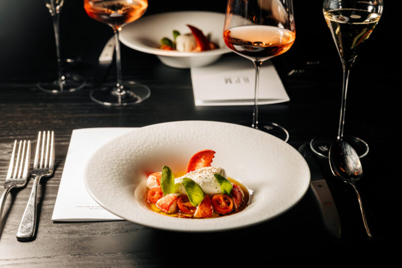 Lobster Caprese dish with a glass of wine 