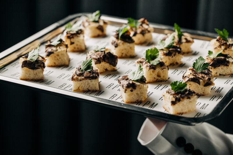 Cremini Mushroom Pizzette bites on a plattaer.