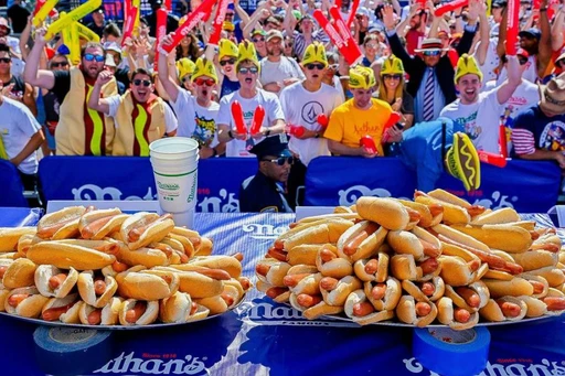 Nathan’s Famous Hot Dog Eating Contest
One of NYC’s favorite July 4th pastimes returns to Coney Island this week, where competitive food eaters will once again challenge each other in the Nathan’s Famous Hot Dog Eating Contest. With both men’s and women’s competitions, there will be a huge race to see who can eat the most hot dogs and buns in 10 minutes!
Although renowned champion and eater Joey Chestnut will not be competing in this year’s event, it’s still sure to be a raucous happening down in Coney Island.