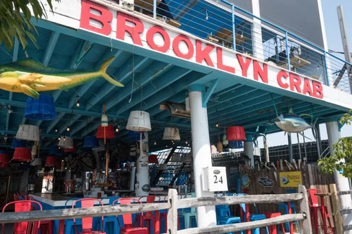 Where To Hang Out By The Water?
When you want a reminder that itâs summer, head to the Brooklyn Crab!
Look out at the water from Brooklyn Crab, and youâll see giant container ships sitting on water thatâll remind you Brooklyn is certainly not a beach town. Even still, this Red Hook spot definitely feels summeryâmaybe itâs the fake sand or crab traps, which will take your mind off the fact that youâre next to warehouse parking lots. Order crab legs, popcorn shrimp, and a few pitchers of beer, and then take off your bib and play some cornhole. Itâs also on the same block as Hometown Bar-B-Que, if youâre looking for surf and turf.
