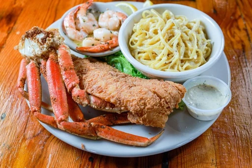 Fried food and cheat days are a match made in heaven, and CJ’s Crab Shack has your back with grouper fingers, fried popcorn shrimp, fried shrimp po’boys, and other classics.
Because portions are huge here, one dish at CJ’s Crab Shack is probably enough to fill you up. That said, why stop there? Other crowd-pleasers include the steak and shrimp, the crab cake dinner, the grouper in a bag, and—of course—the snow crab dinner. There’s also a full bar, so expect to be here for a while.