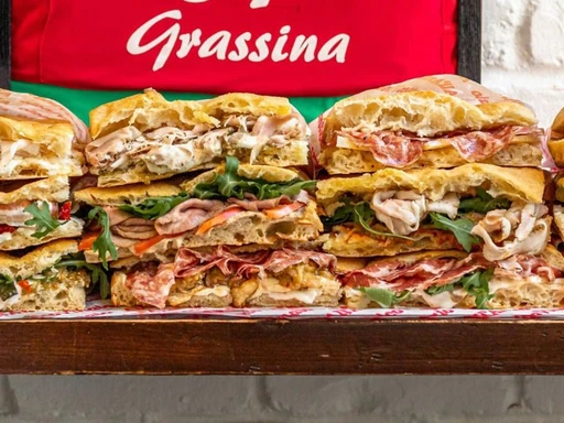 Take a bite out of the best sandwiches in Los Angeles!
Italy’s most famous sandwich shop has been drawing crowds to its Florence location since 1991, and we were lucky enough to gain an outpost of All’Antico Vinaio here in L.A. just last year.
These globally-famous creations are made with Tuscan schiacciata bread and stuffed with mouthwatering ingredients like prosciutto, truffle honey, stracchino, spicy eggplant, artichoke cream, pancetta, sun dried tomatoes, and so many more. If you’re on the hunt for the best Italian sandwiches in Los Angeles, we’re not sure you can better than this.