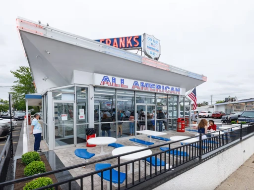 All American Hamburger Drive-In
You can smell the beef from the strip mall parking lot across the street. A breeze off South Oyster Bay carries the scent north until it reaches your nostrils, and before you know it you’re crossing Merrick Road to line up at the counter at All American Hamburger Drive-In.
This Massapequa institution opened in 1963, and its prices haven’t changed much since. For $2, you can get a patty the size of a silver dollar on a griddled bun smeared with ketchup and diced onion. If you need something more substantial, there’s also the quarter pounder served in a custom foil envelope. Add a hot dog and a packet of wilted, salty, golden-brown fries, and you’re still looking at a meal that’ll run you roughly $10.