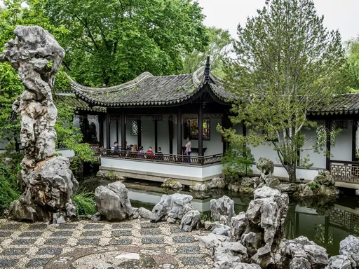 Hidden Gem in NYC - Chinese Scholar’s Garden 🌳
Summer is the perfect time to explore some of the city’s fabulous gardens. One of New York City’s greatest hidden gems is the Chinese Scholar’s Garden, located at Snug Harbor Cultural Center and Botanical Garden in Staten Island. The design is based on gardens from the Ming Dynasty in China, and one of the few authentic gardens that were built in America. All the materials you see here (including the rocks and the tiles on the floor!) were made or sourced in China.
The Chinese Scholar Garden has much to explore! There are eight pavilions, three ponds with koi fish, a waterfall, and many picturesque areas, including the unique shaped doorways seen on this clip. It’s a treasure.
Why a hidden gem? Because It’s hard to find it! The NYCSG is behind a stone wall and not visible from the road. To get to the entrance you must walk through a cottage. The sign marking this is small and easy to miss. It truly is hidden!