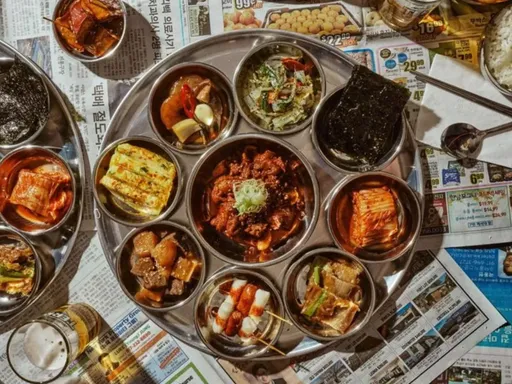 Kisa, short for kisa sikdang (also spelled gisa sikdang), or “driver’s restaurant,” is an homage to Korean diners that emerged in the ’80s catering to taxi drivers.
The spot echoes kisas in Korea, with vintage TVs, wall-mounted fans, Korean calendars, and a coin-slot coffee machine. There’s only one dish on the menu — it comes on a tray with seasonally-changing banchan. All there is to do is pick a main: There’s jeyuk (spicy pork); bulgogi; and jingeo bokkeum (spicy squid). The team recently added lunch and reservations.