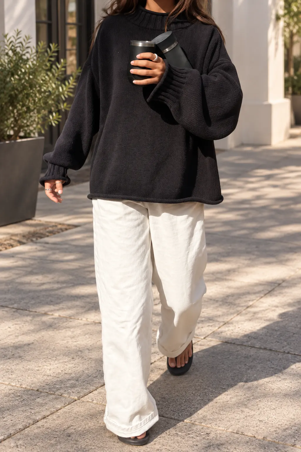Black Sweater and White Wide-Leg Trousers Outfit: black oversized sweater, white wide-leg trousers and black flats in black and white.