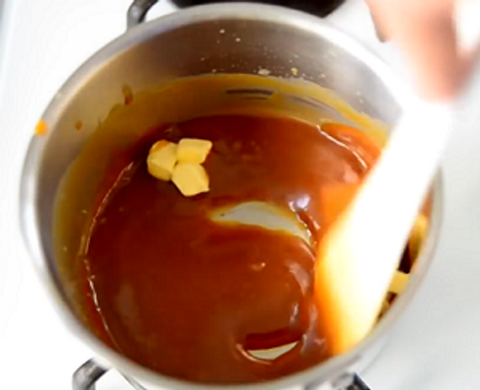 adding butter to caramel sauce