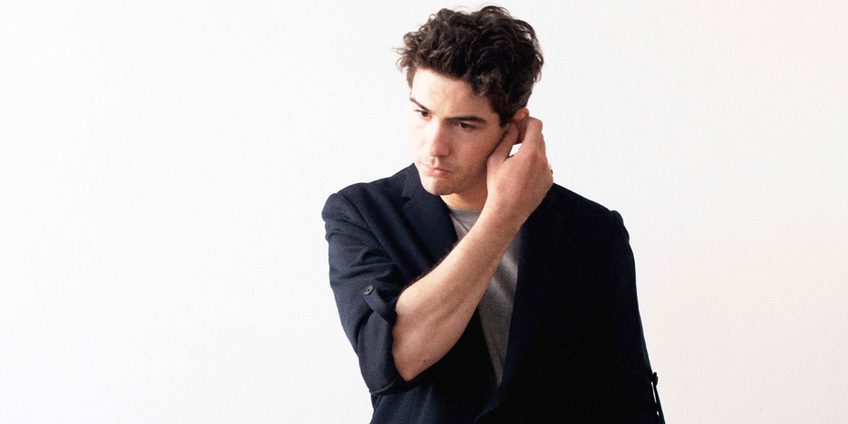 Tahar Rahim in suit portrayed looking away from the camera