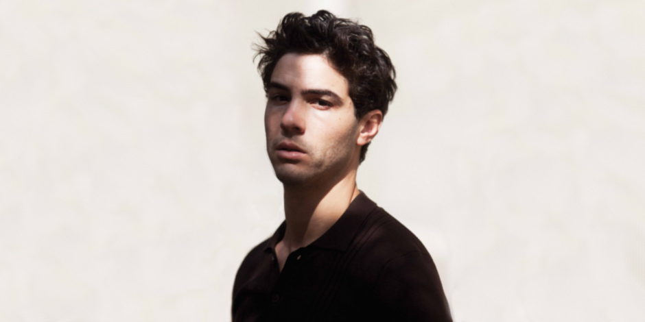 Tahar Rahim in black shirt looking at the camera