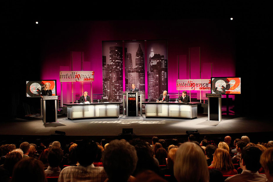 Arianna Huffington at podium. Left to right: David Brooks, John Donvan, Zev Chafets, and PJ O'Rourke. Credit: Chris Vultaggio