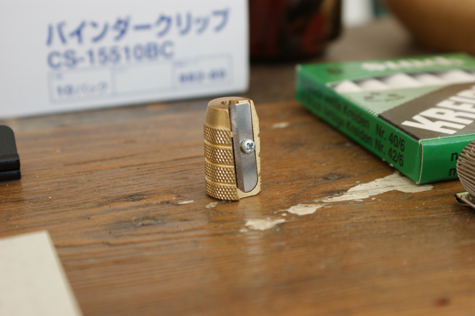 German Barrell sharpner On the desk where Tom sits is an array of stationary to tempt anyone who dreams of a perfectly aligned workspace. This German barrel sharpener sits discretely amongst the ranks.