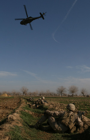 A helicopter comes in for an emergency medical evacuation, while Marines and Afghan National Army soldiers with Bravo Company, 1st Battalion, 6th Marine Regiment provide overwatch, Feb. 13, on the outskirts of the city of Marjah, Afghanistan. Marines with Bravo and Alpha Co., 1/6 inserted into the city at night by helicopters as part of a large-scale offensive aimed at routing the Taliban from their last-known stronghold.  Photograph by Lance Cpl. James Clark  Regimental Combat Team 7 