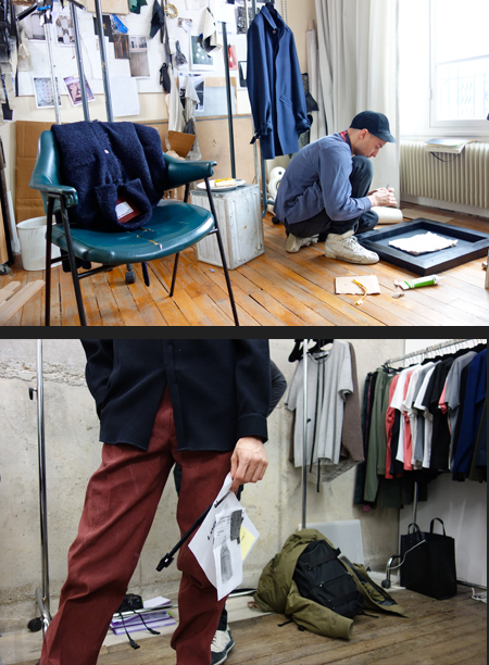 In the studio, working and rails of clothes