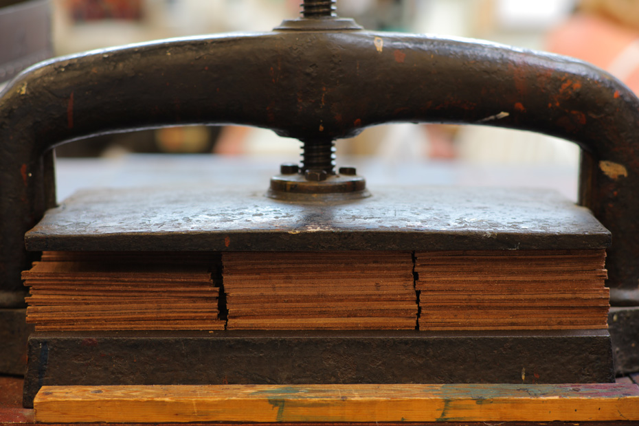 Leather being pressed in a purpose-made vice