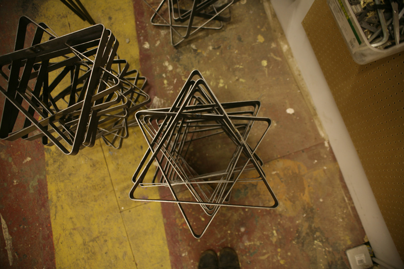 Chairs stacked (triangular shape making them appear as star formations) - 200 chair project, Assemble studio