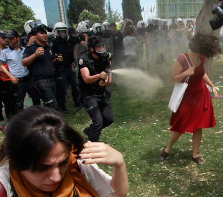 Woman-in-red-dress-being-sprayed-with-teargas,-Turkey.-June-2013.-Reuters