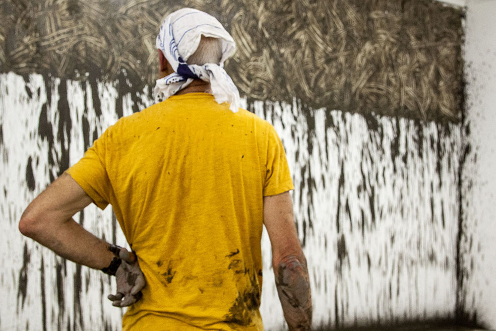 Richard Long installing Muddy Water Falls, 2015. Photograph by Stephen Jackson