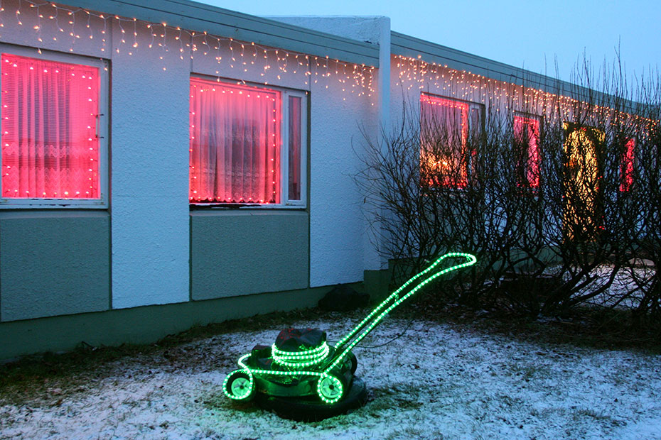 A lawnmower decorated with Xmas lights