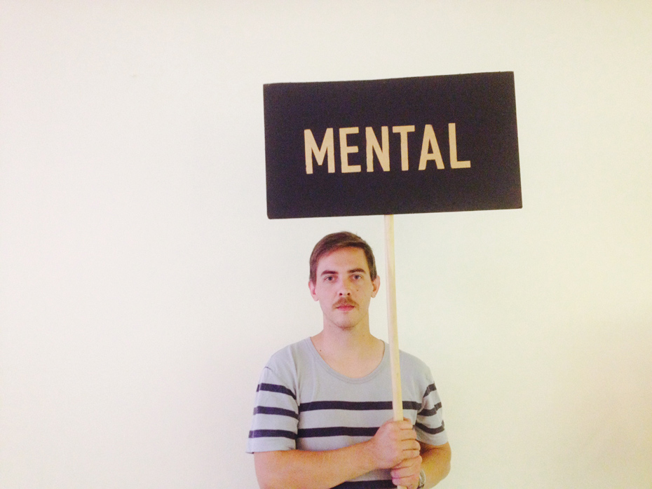 The Vacuum Cleaner holding a sign saying 'Mental' by Amy Hicks