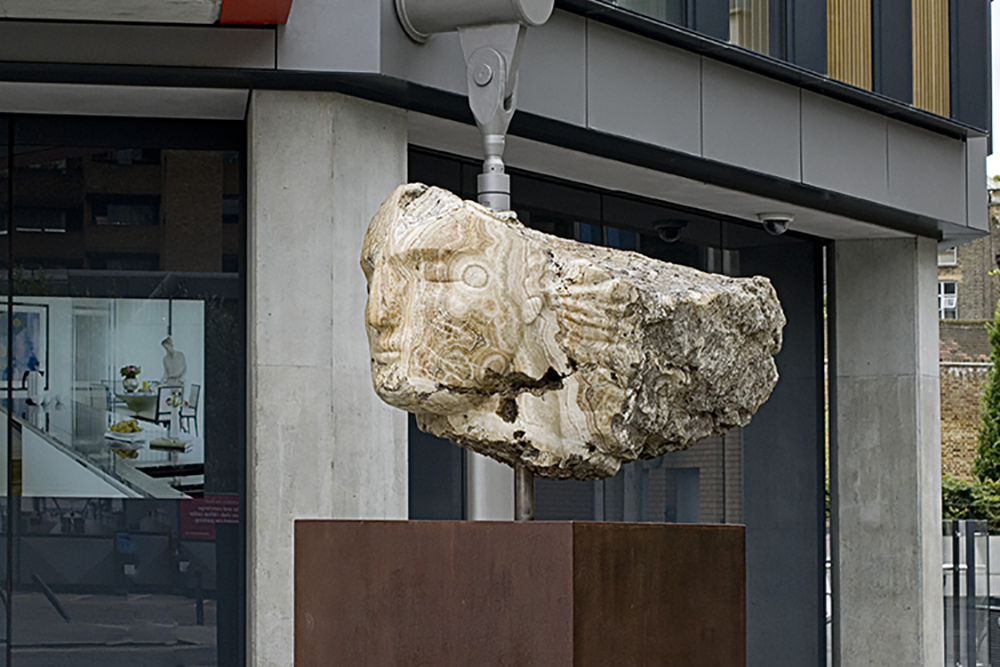 Emily Young, Tempesta (Etruscan goddess of the wind), 90x116x178 cm, 2012, in situ at NEO Bankside. © Emily Young, courtesy of The Fine Art Society