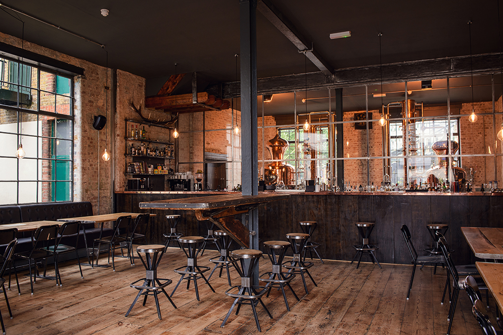 The distillery's bar, with two German-made copper stills in the background