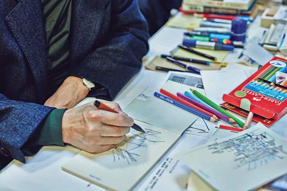 Ando sketches the interior of his studio on a personalised notepad