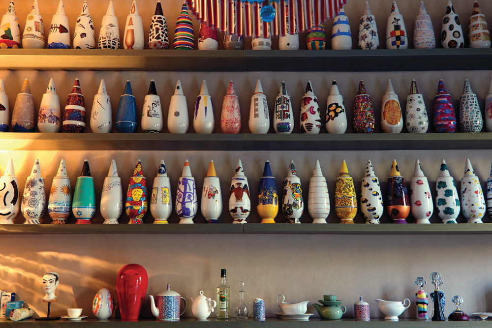 Vases designed by Mending for Alessi in 1992 and decorated by 100 different artists fill shelves in the kitchen. 