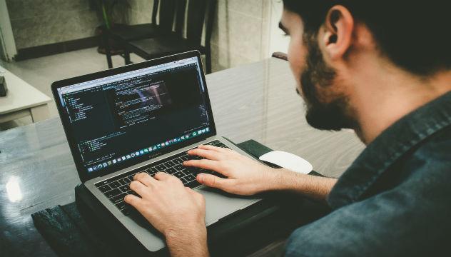 man implementing a crm on laptop