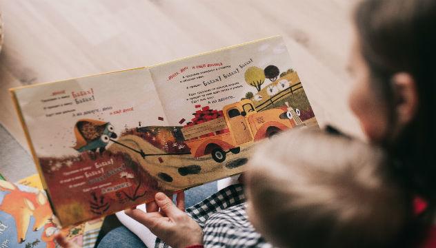 women reading a child a book