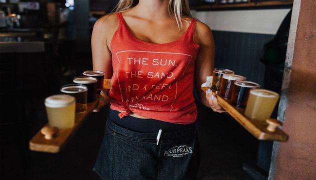 woman carrying beers