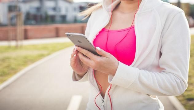 woman in activewear checking her phone