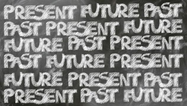 3 tenses past future and present written on a blackboard