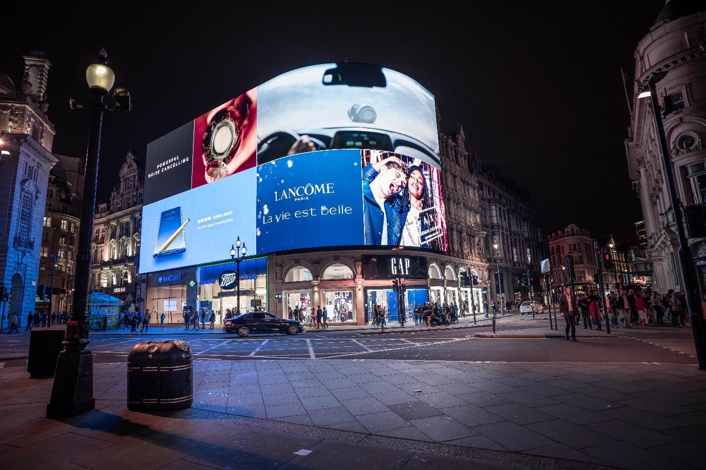 Billboard Adverts Above Shops at Night