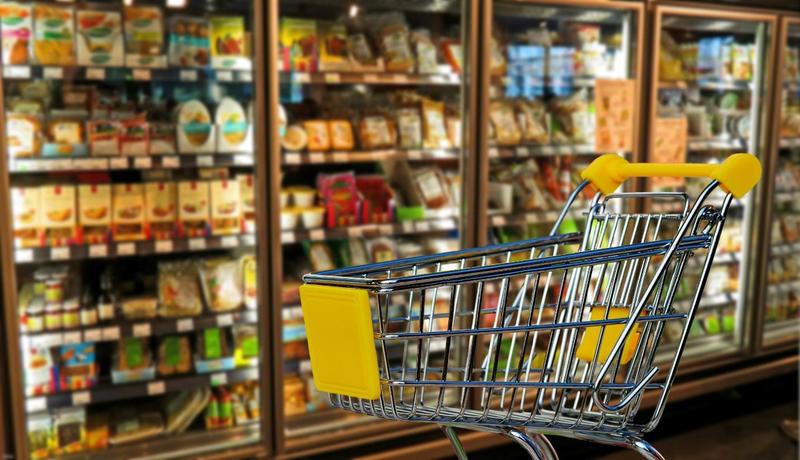 Retail Shopping Trolley in Front of a Freezer Section