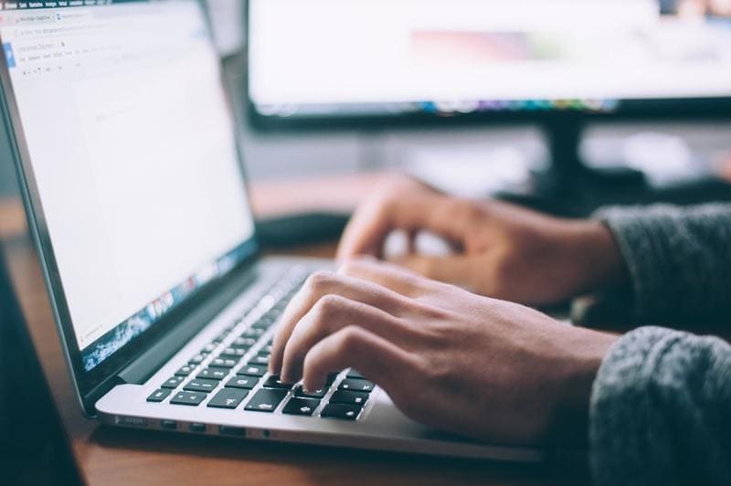 Teacher Writing on a Laptop