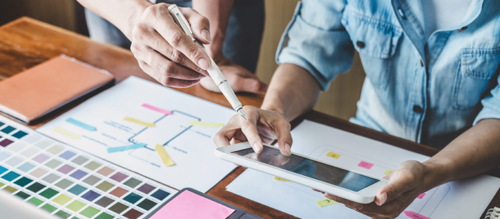 Team of Creative Web/Graphic Designer planning, drawing website