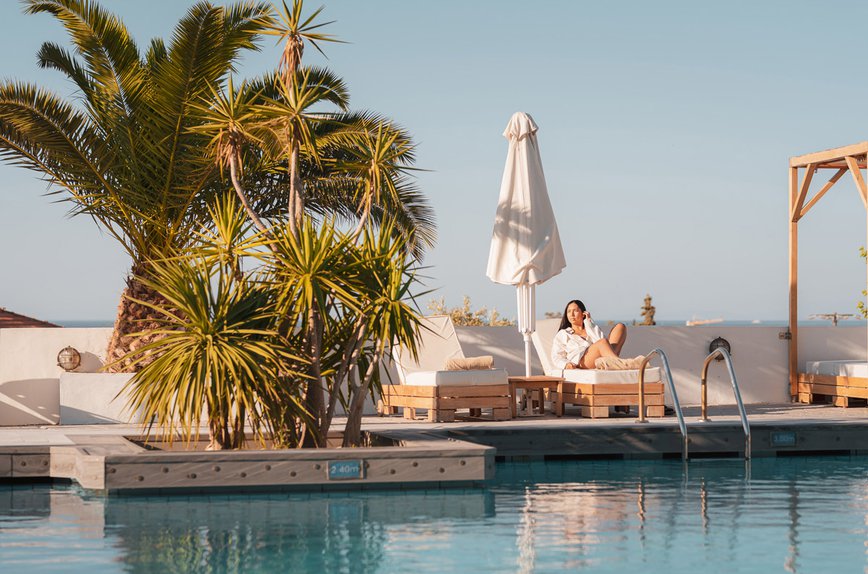 Our pool during daytime with the deck chairs