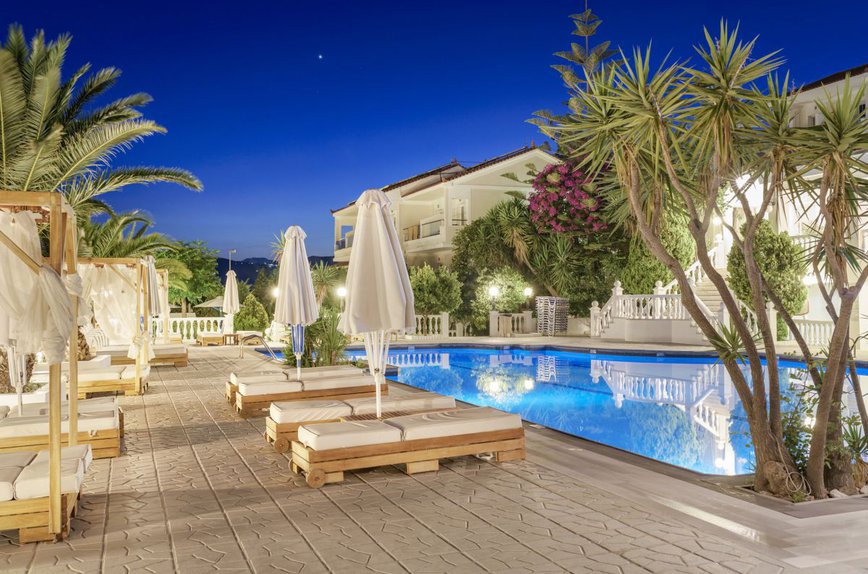 Our pool during daytime with the deck chairs