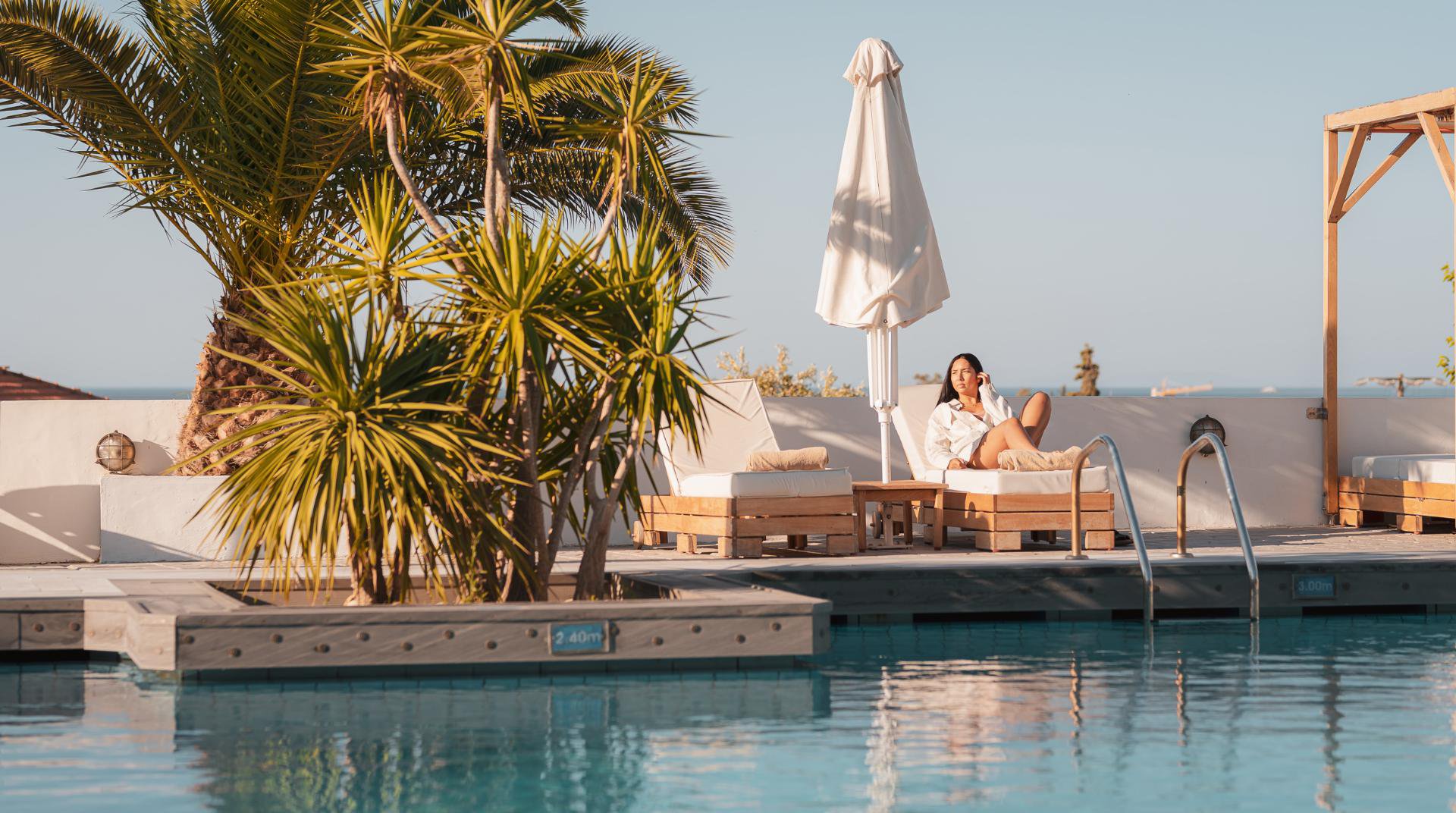 Our pool during daytime with the deck chairs