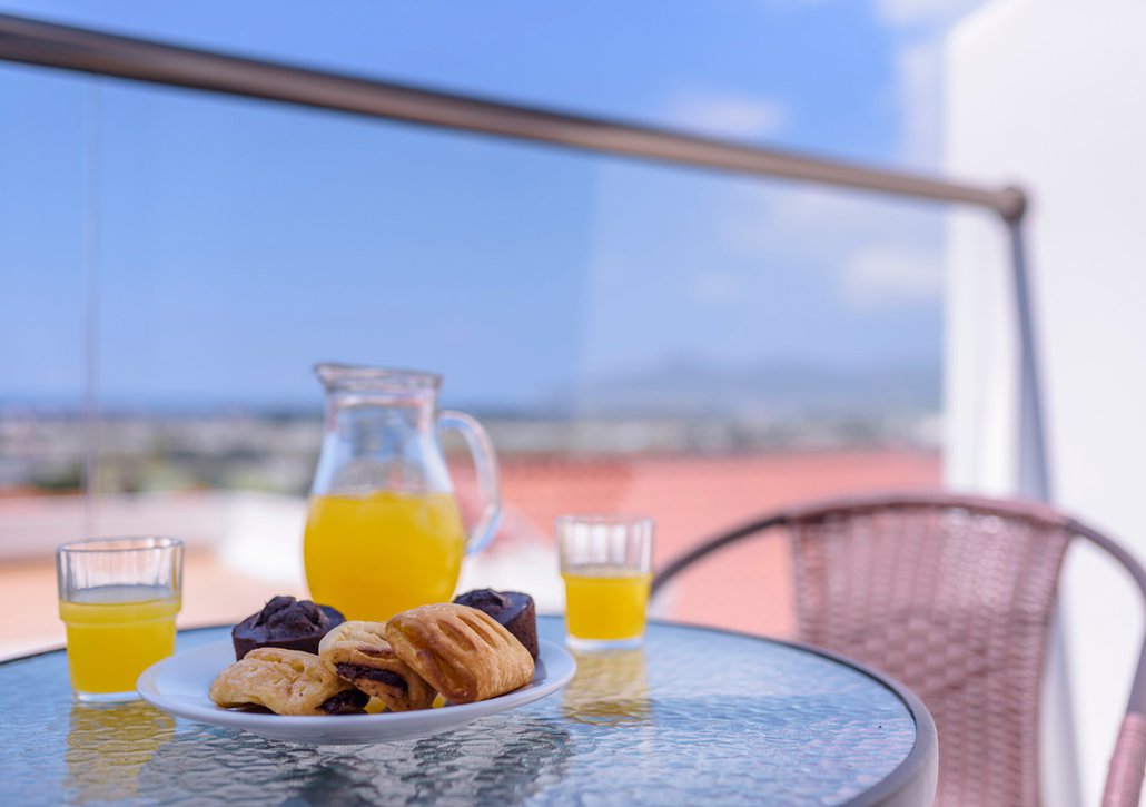 Breakfast on plate from our buffet on the balcony of your room