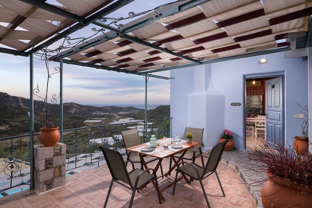 Sarakinas Residence, balcony with a table and panoramic view