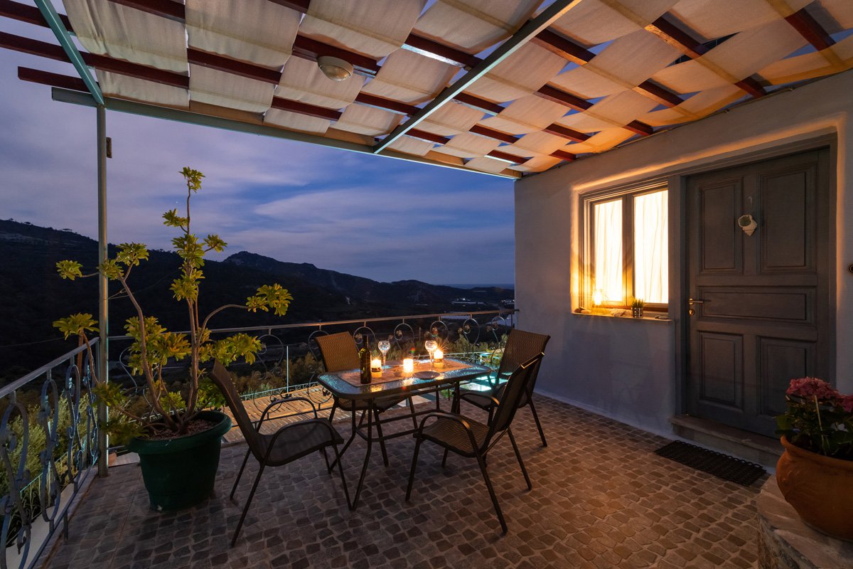 Sarakinas Residence, balcony with a table and panoramic view at night