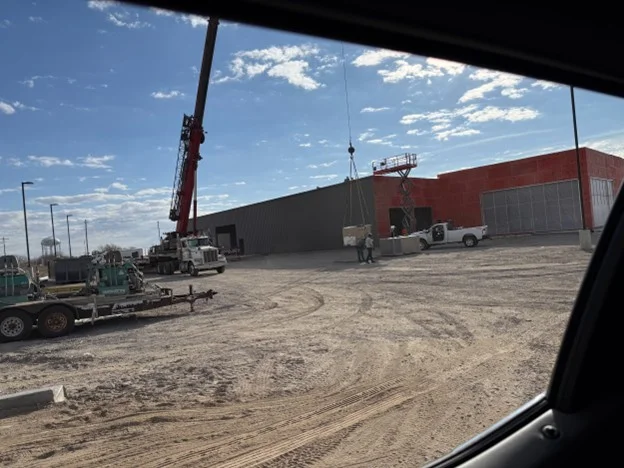 Crane installing A/C units on the new Wagner building