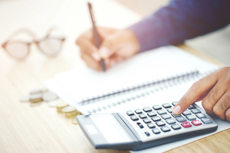 Person calculating and writing